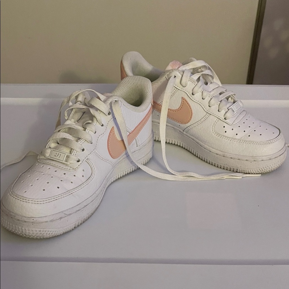 Nike White Low-Top Sneakers with Light Pink Swoosh